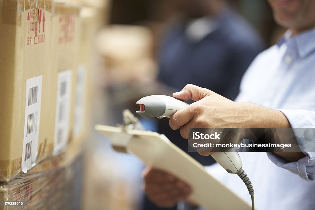 Worker Scanning Package In Warehouse Close Up Of Worker Scanning Package In Warehouse Warehouse Stock Photo