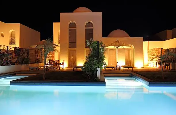 Luxury holiday villa with swimming pool in the evening (oriental style).