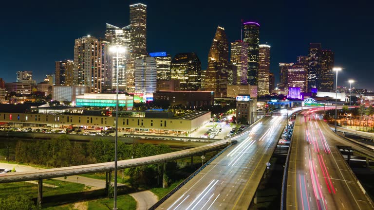 Aerial Hyperlapse Drone Fly Above Highway of Houston Texas USA at Night Lighting. Establishing Drone shot of City of Houston at night