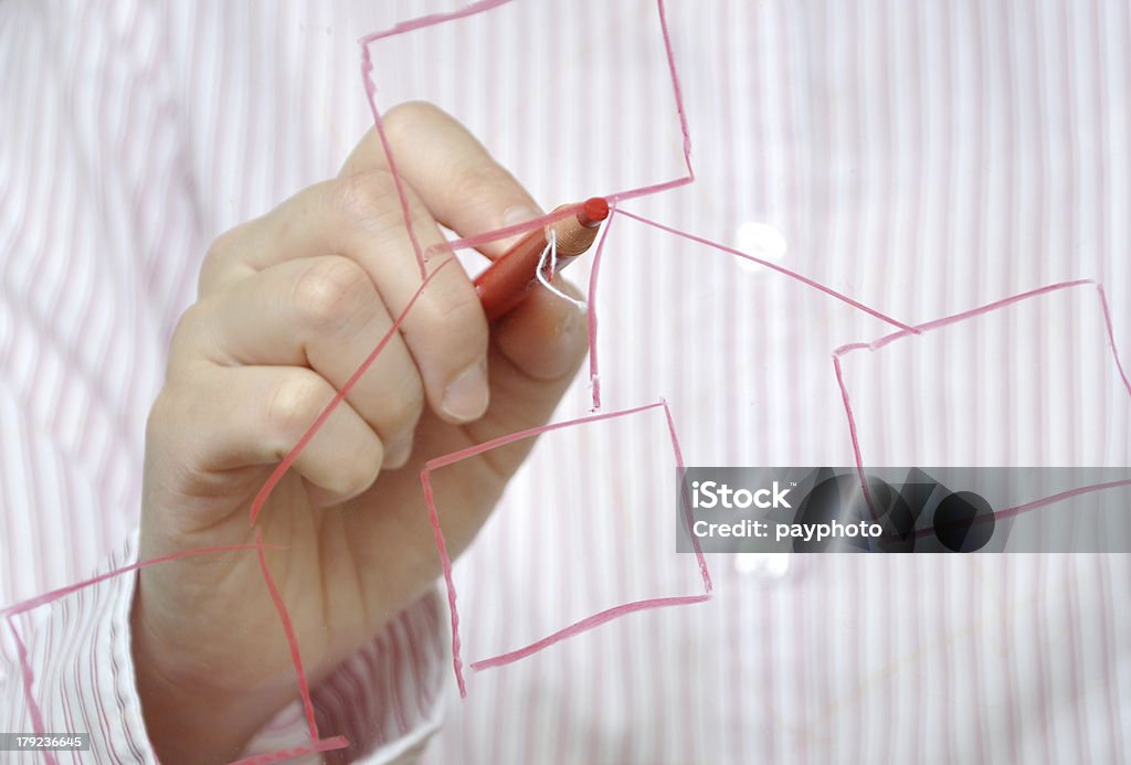 Business woman drawing organization chart with a pen Organization Chart Stock Photo