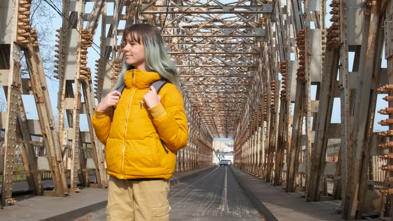 Girl enjoy the sunny time on bridge.