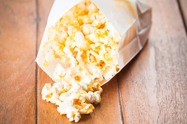 istock Popcorn paper bag opened with corn spilling out 179237616
