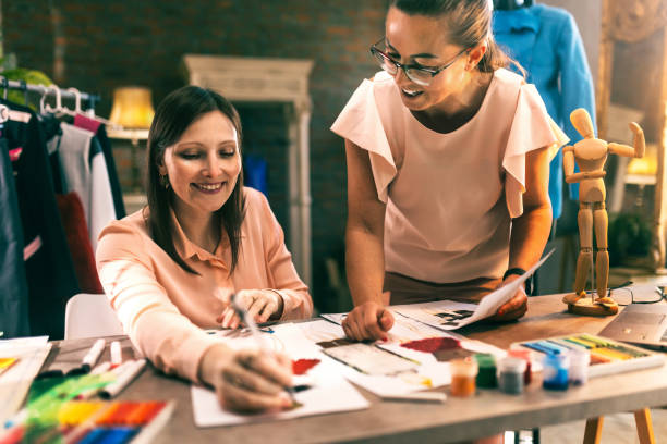 istock Fashion designer looking at sketch on working table in workshop 1792389507