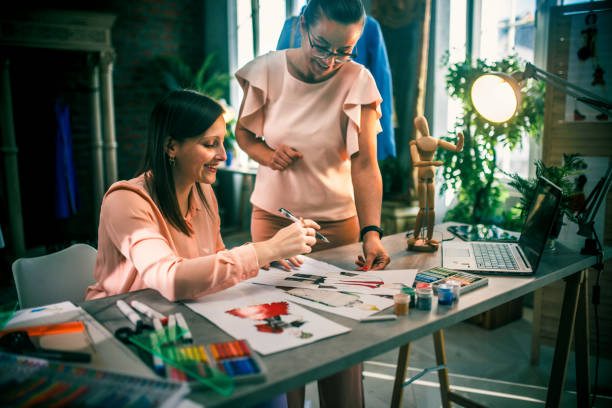 istock Fashion designer looking at sketch on working table in workshop 1792390030