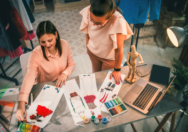 istock Fashion designer looking at sketch on working table in workshop 1792391062