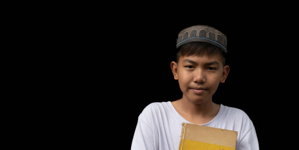 Asian muslim or islamic boy isolated on back background with clipping paths.