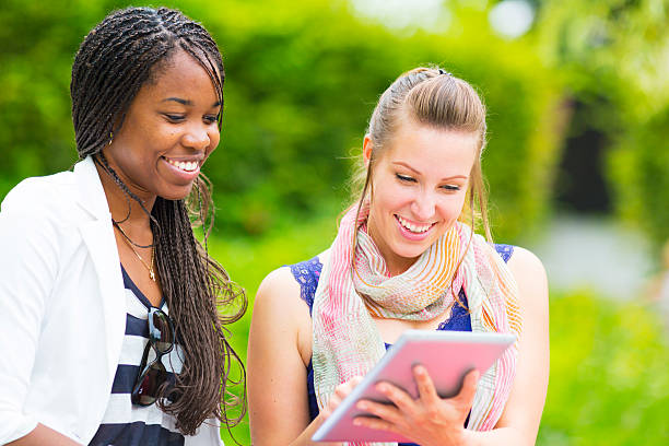istock Young women using digital tablet in the park 179244005