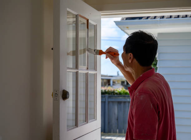 istock Man painting door frames with a paint brush. Home renovation project. 1792440874