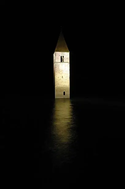 "The Spire of a romanesque church in Graun, Italy - it is everything that is left of a village, that was submerged by a reservoir thats now called Lake Reschen - long exposure shot taken at night"