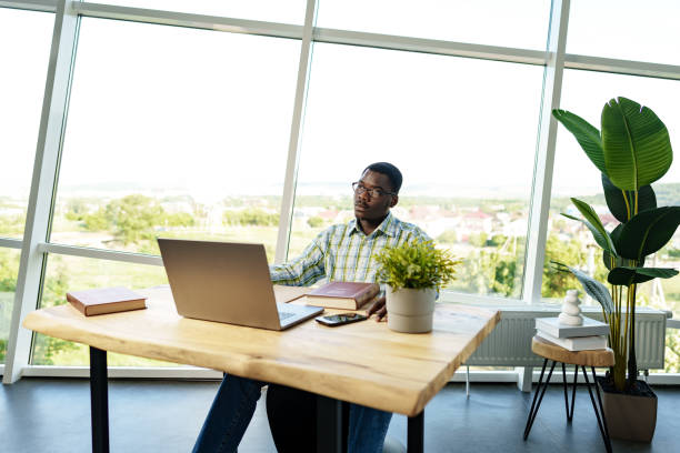 istock Serious concentrated african man studying or working with laptop indoors 1792448233