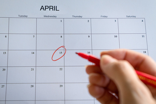 Calendar date in the month of April circled in red. Appointment or meeting reminder.