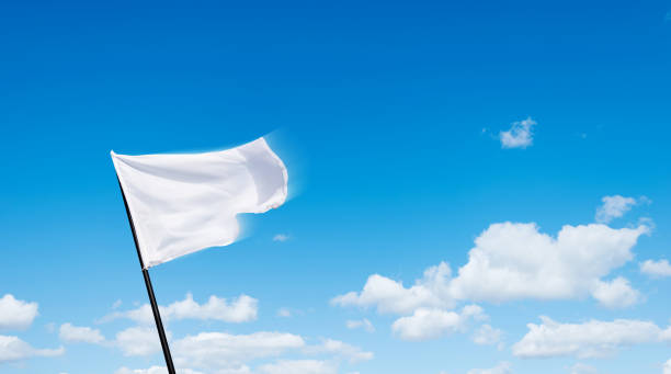 istock White flag flying against blue sky background 1792459210