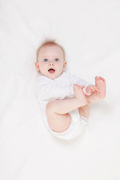 istock Cute baby with beautiful blue eyes lying in white bed 179246202