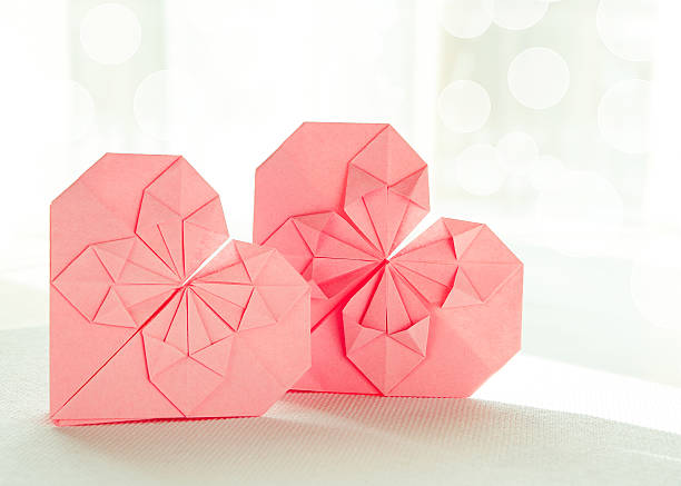 Two origami paper hearts stock photo