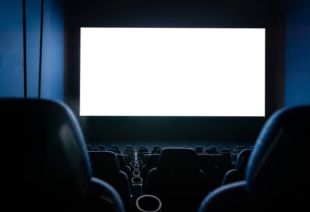 istock Dark movie theatre interior with screen and chairs 1792463021