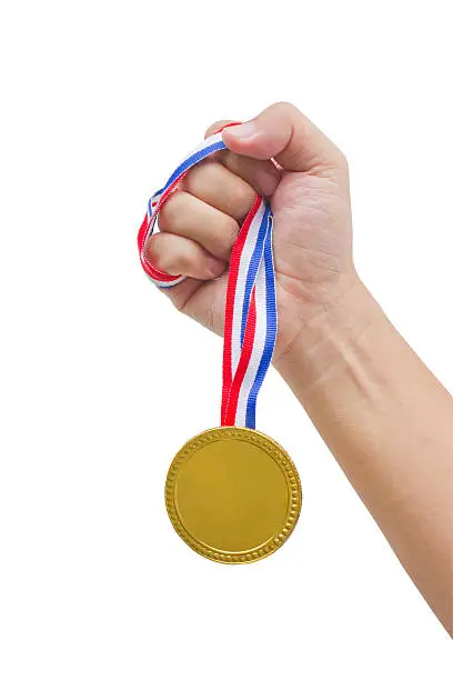 Photo of Golden medal in man's hand isolated on white background.
