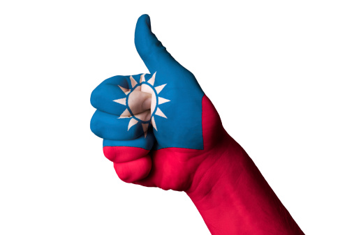 Hand with thumb up gesture in colored taiwan national flag as symbol of excellence, achievement, good, - for tourism and touristic advertising, positive political, cultural, social management of country