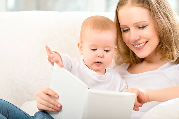 istock Mother reading book a little baby 179247348