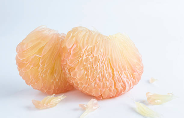 istock Two slices of ripe grapefruit on a white background 1792480665