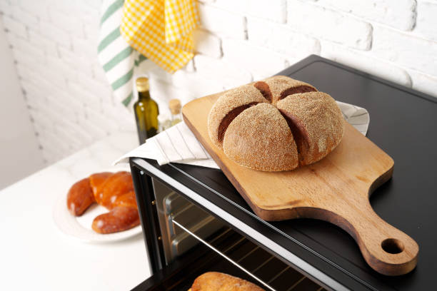istock Freshly baked bread in mini oven in the kitchen 1792483924