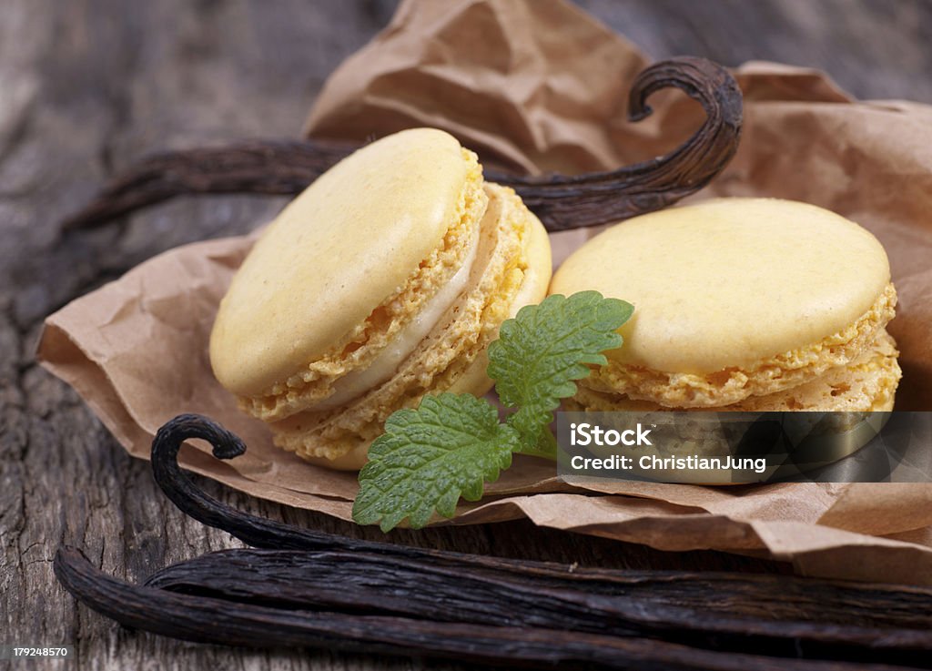 Macaroons with vanilla beans Macaroons with vanilla beans on wooden ground Cake Stock Photo