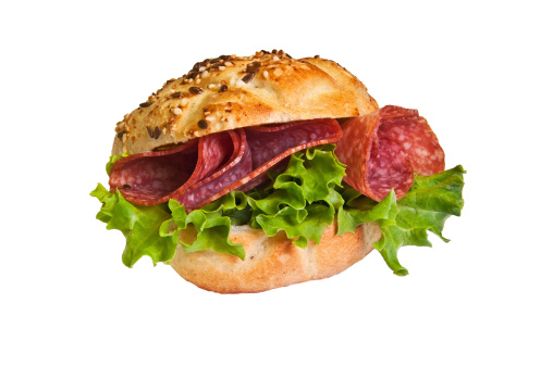 Sandwich - a bread roll with sausage and lettuce fillings.