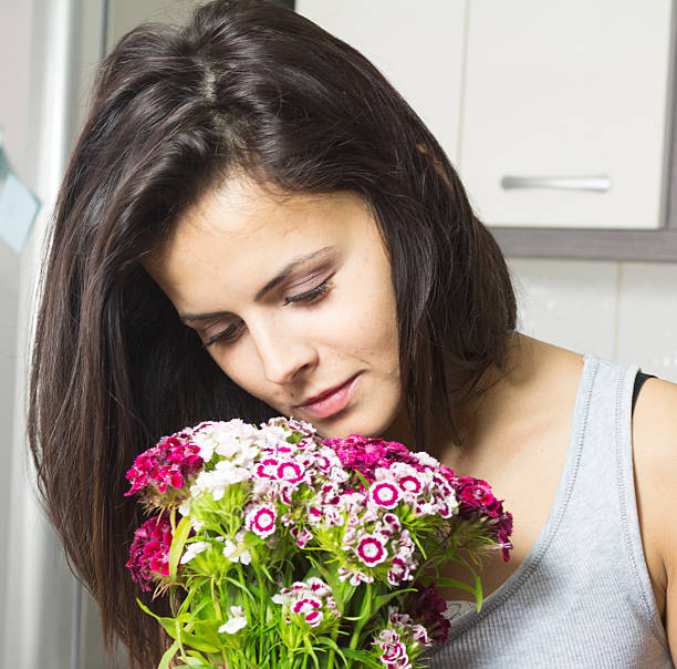 istock girl smelling flowers 179249838