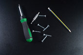 Screws, screwdriver and pencil