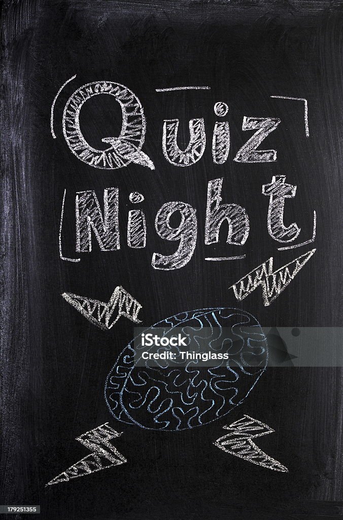 Quiz Night Quiz Night announcement on a used blackboard with a chalk drawing of a human brain fizzing with lightening bolts of knowledge and intelligence. Quiz Night Stock Photo