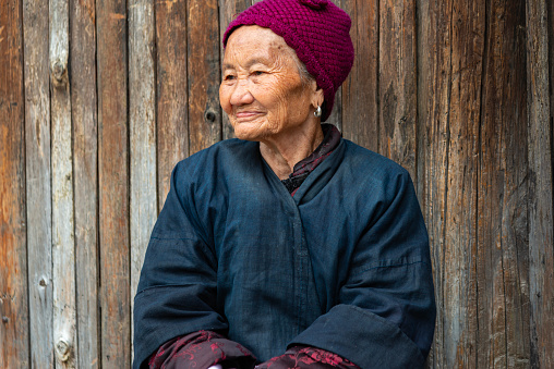 Senior Chinese woman, from the Dong People minority tribe in the village of Chengyang. Dong People Portrait, Chengyang, Guangxi, China.