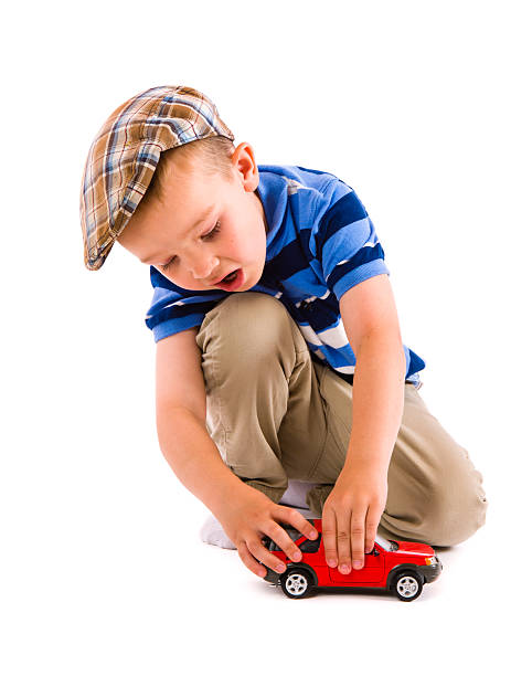 Portrait of cute little kid looking out of car window and smiling happily in sunlight