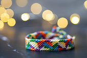 colorful artisanal Brazilian bracelets in front of a bokeh background