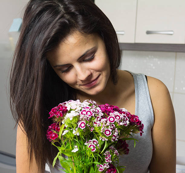 istock girl smelling flowers 179253374