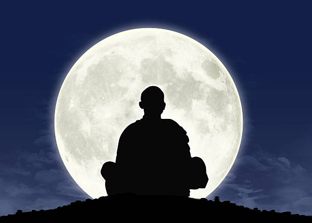 istock monk in meditation at the full moon 179253869