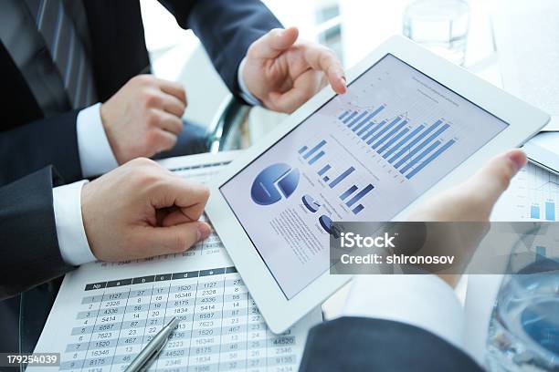 Discussing Data Stock Photo - Download Image Now - Explaining, Finance, Using Digital Tablet