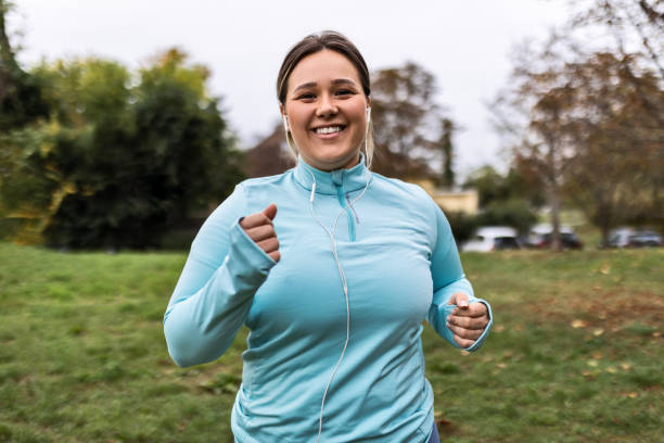 istock Young Chubby Woman Embracing the Run 1792546690