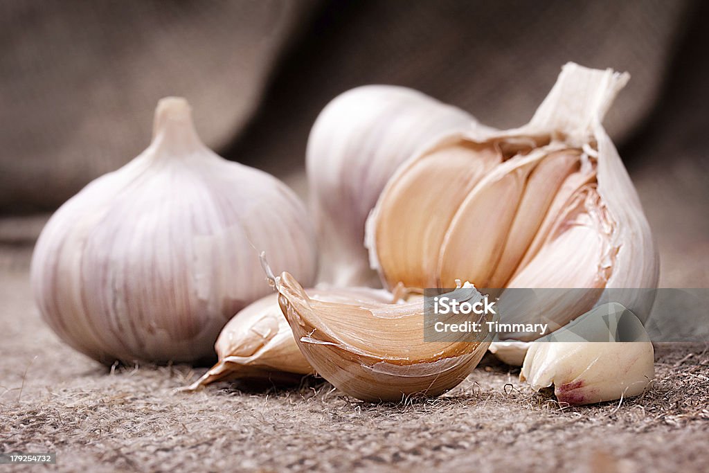 Fragrant garlic on background of coarse cloth Bag Stock Photo