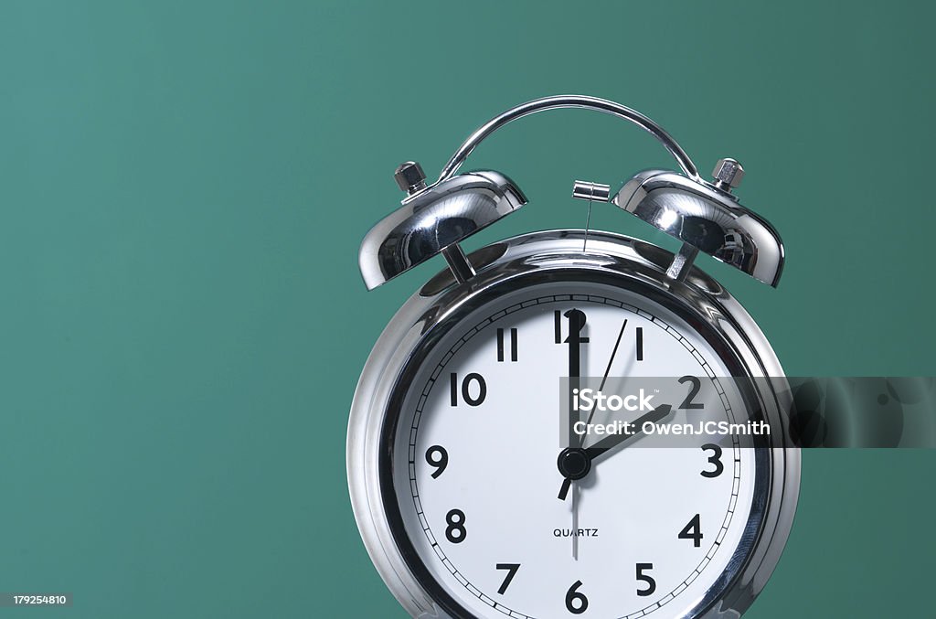 Alarm clock against Green Alarm Clock against green background. 2 O'Clock Stock Photo