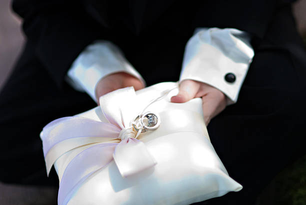 Wedding Ring Bearer A wedding ring bearer hold the rings on a beautiful silk pillow ring bearer stock pictures, royalty-free photos & images