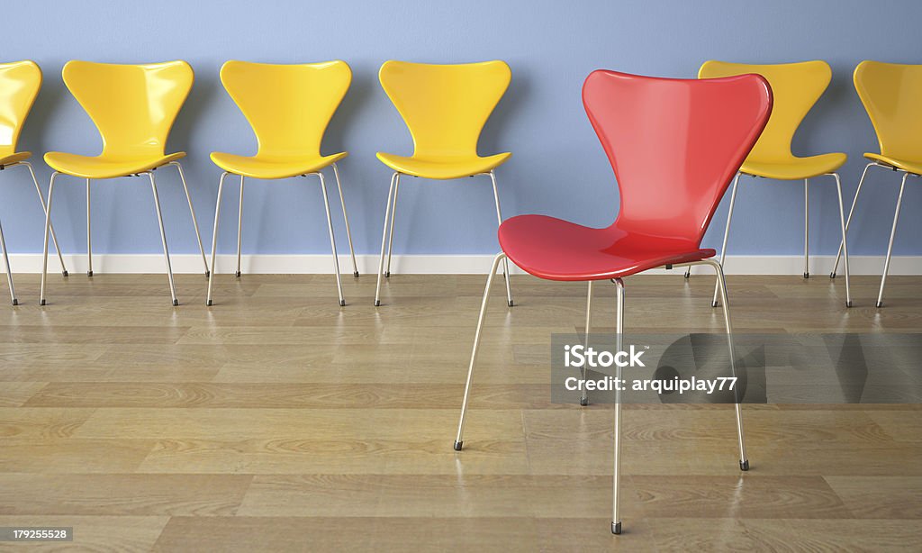 row of chairs on blue wall interior design row of yellow chairs against a blue wall with one red in front Abstract Stock Photo