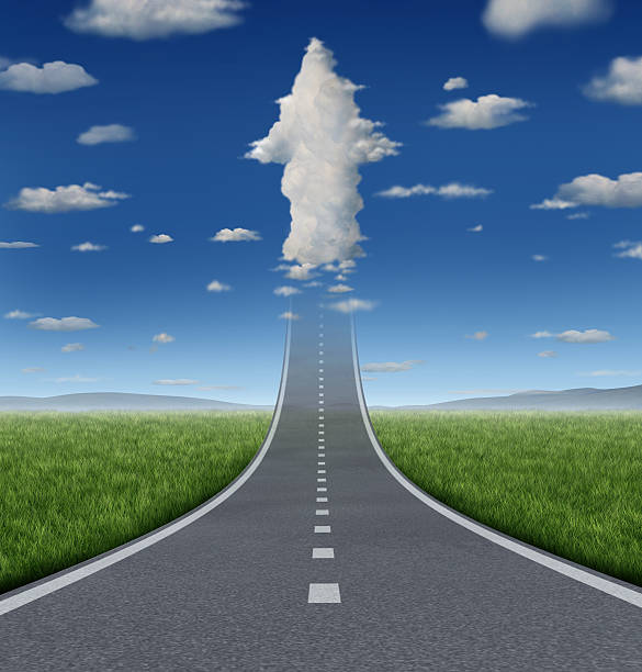 Endless road straightaway implying there are no limits No limits success concept with a road or highway going forward fading into the sky with a group of clouds shaped as an upward arrow as a business symbol of financial freedom and aspirations. road to success stock pictures, royalty-free photos & images