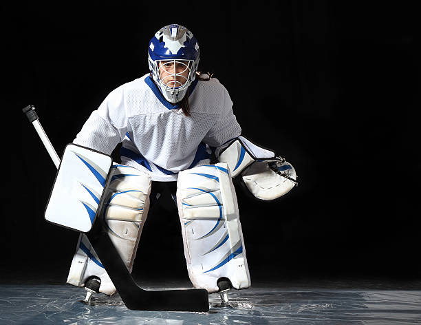 istock Young hockey goalie on a dark background 179256004