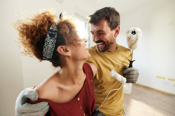 istock Cheerful couple talking during home renovation process. 1792560488