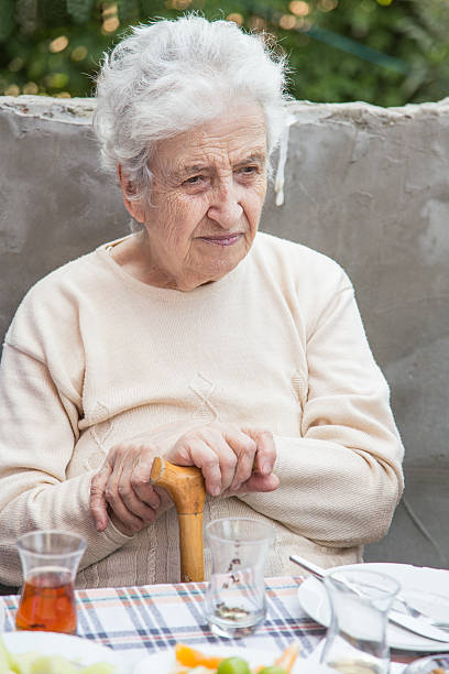 istock senior woman at breakfast table 179256430
