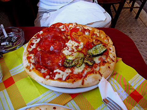 The pizza in the small cafe on the street in Rome, Italy