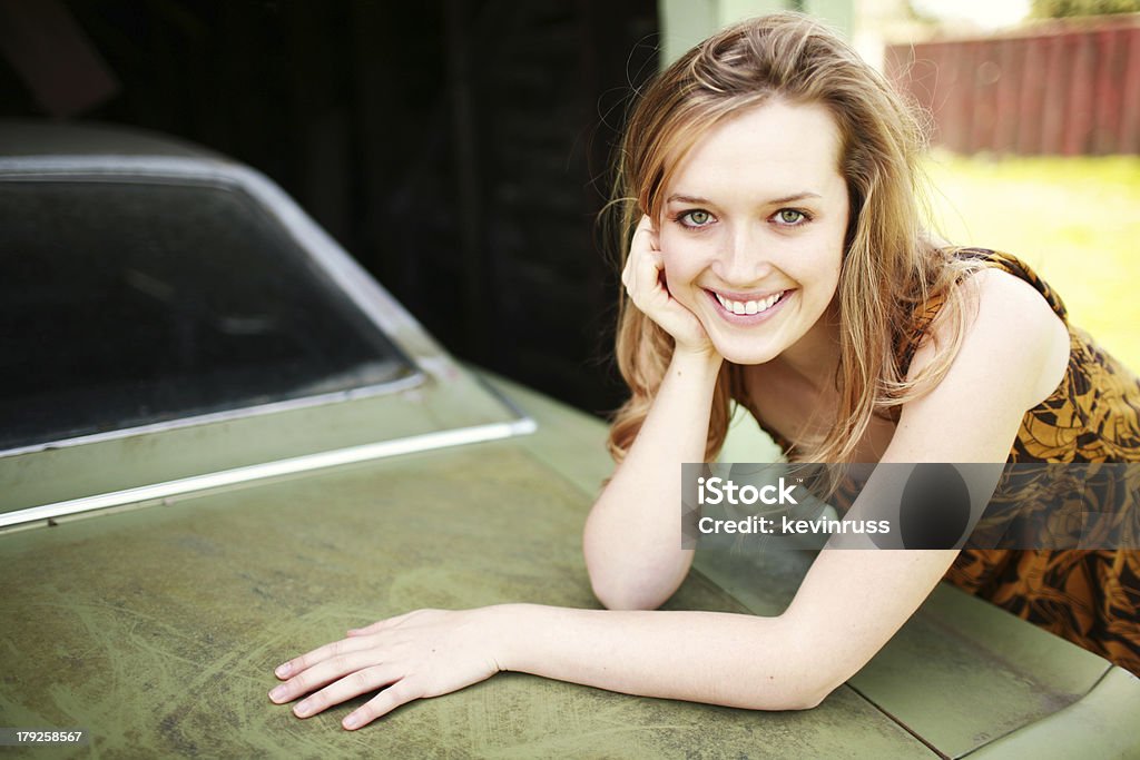 Beautiful Girl Leaning Over Dirty Old Car young woman in the spring time 20-24 Years Stock Photo