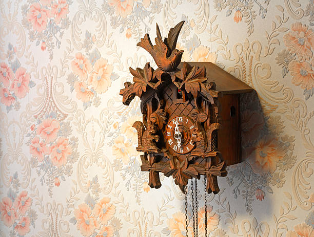 istock Vintage wooden cuckoo clock over a rose-pattern wall 179259243