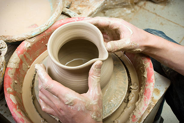 istock hands of a potter, creating an earthen jar 179259524