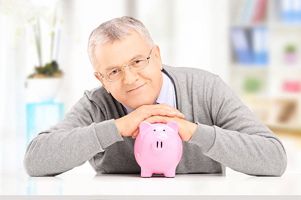 istock Satisfied gentleman posing over a piggy bank 179260008