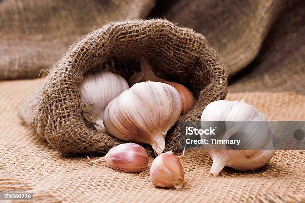 Fragrant Garlic On Background Of Coarse Cloth Stock Photo - Download Image Now - Bag, Food, Garlic